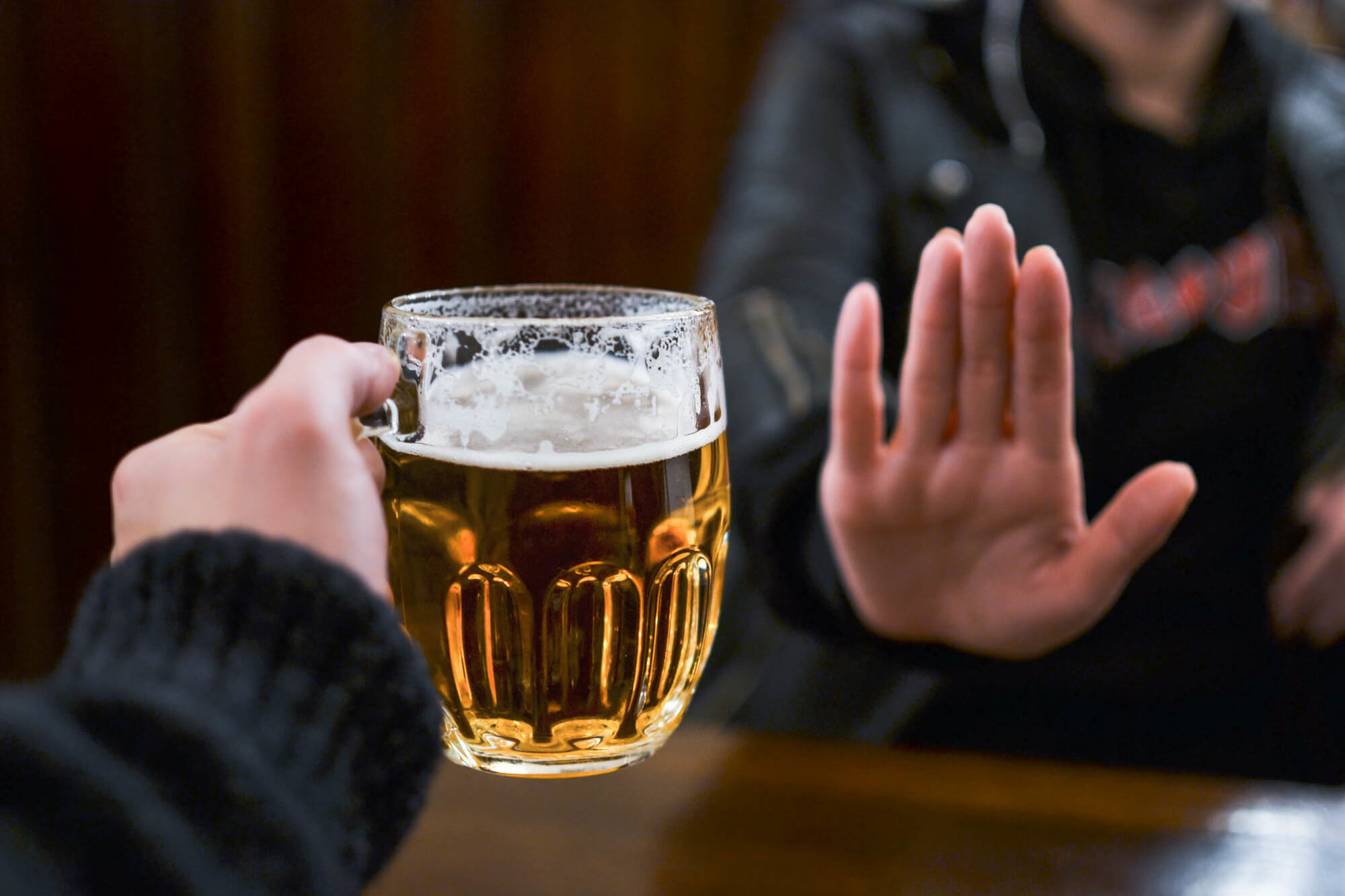 fighting alcoholism Girl refusing another glass of beer