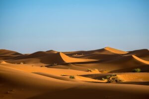 blue sky with desert sand dunes